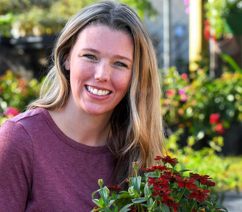 A woman holding a potted plant